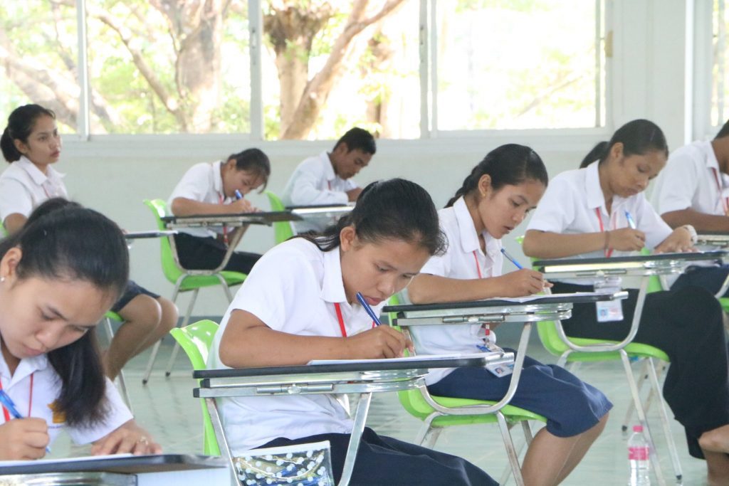 students in Cambodia writing exams